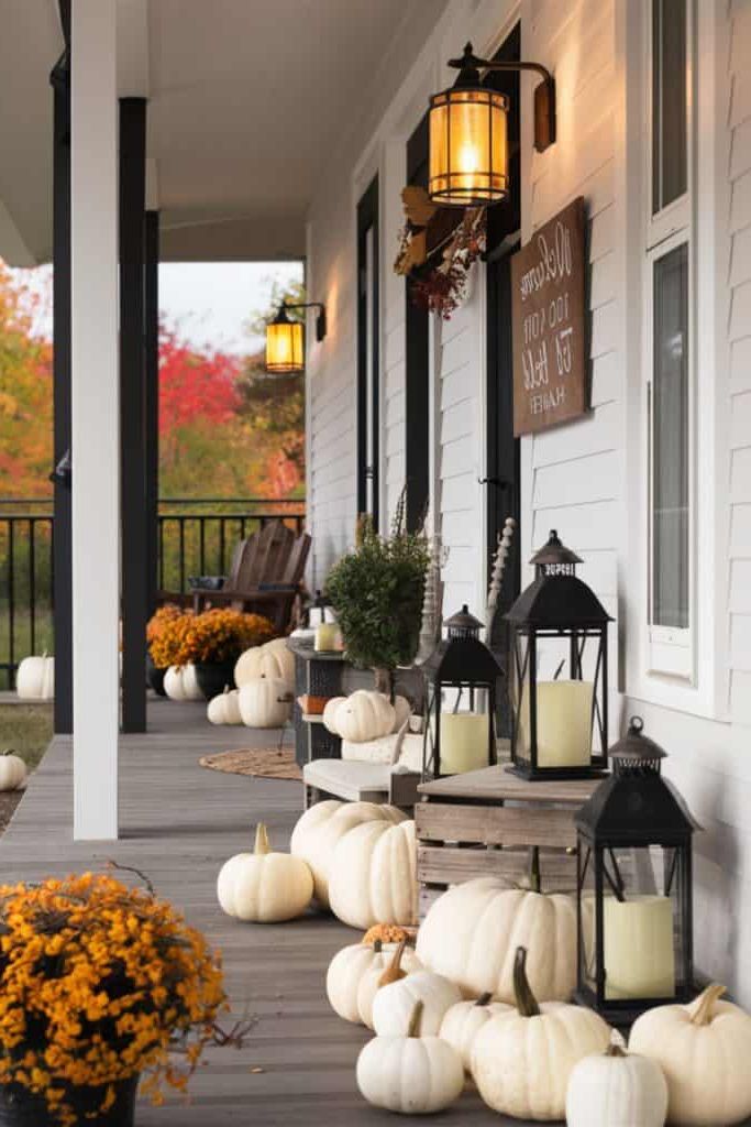 Modern farmhouse fall porch with lanterns and pumpkins