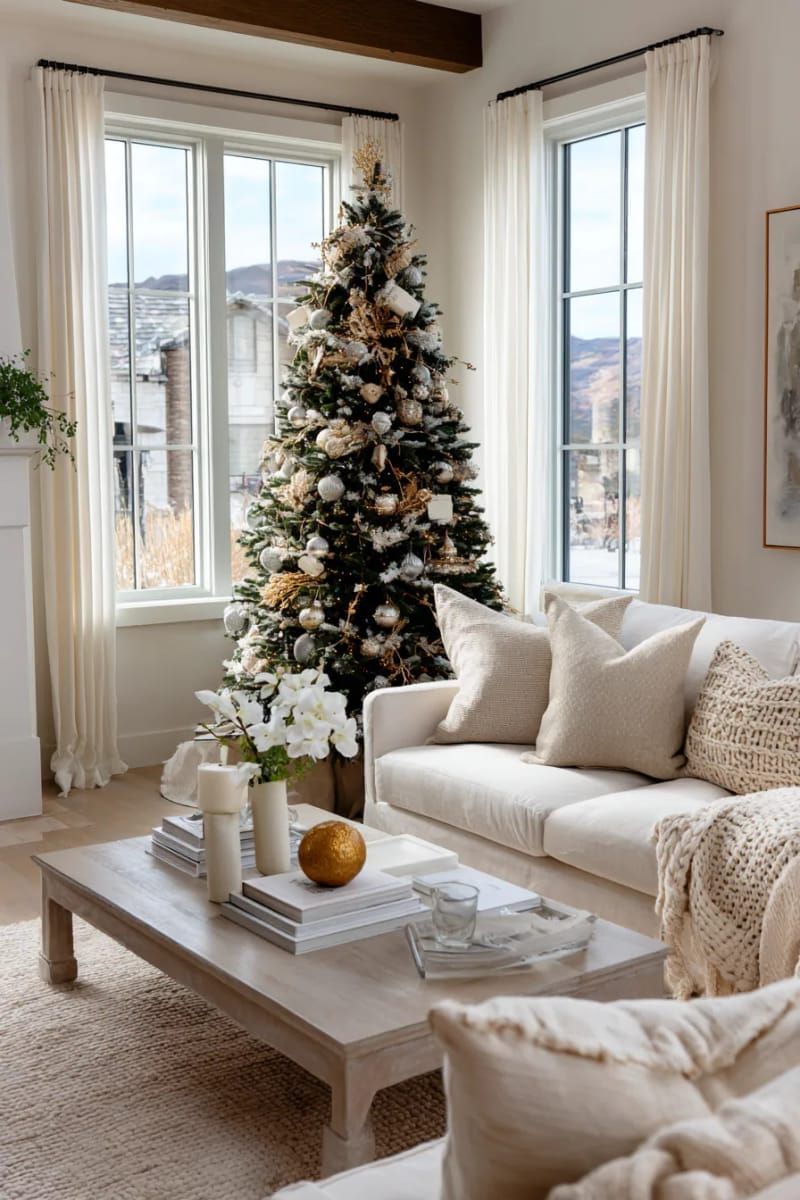 minimalist tree decorated only with white and gold ornaments 1