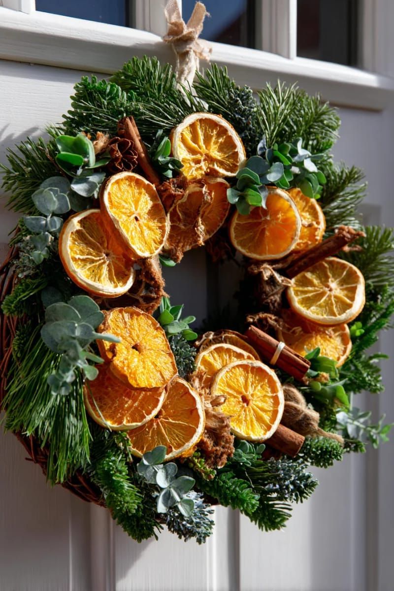 dried orange slice wreath with cinnamon sticks and greenery for front door 1