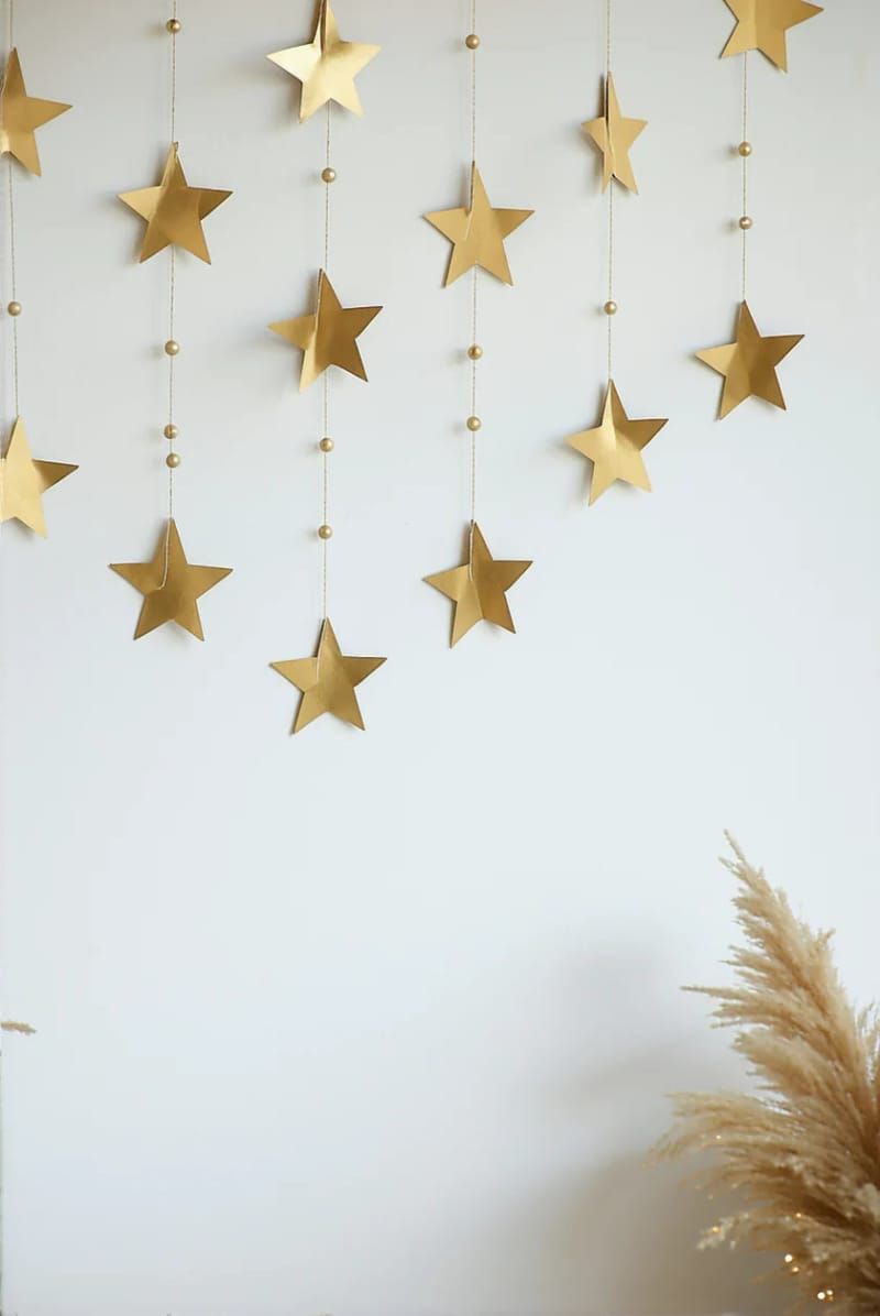 minimalist star garland from cardboard, gold paint, and string 1