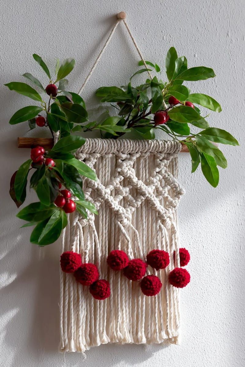 boho macramé wall hanging with tiny red pom-poms and greenery 1
