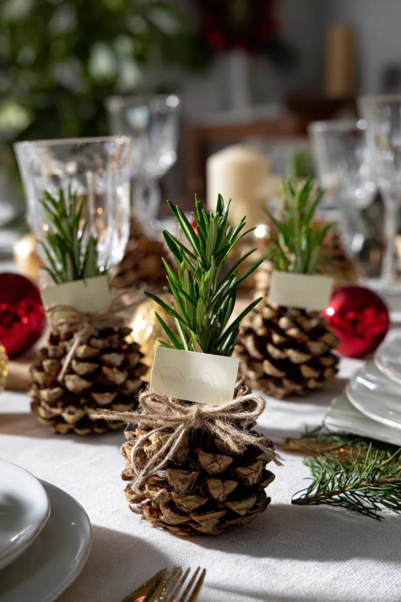 pinecone place cards tied with twine and a sprig of rosemary 1