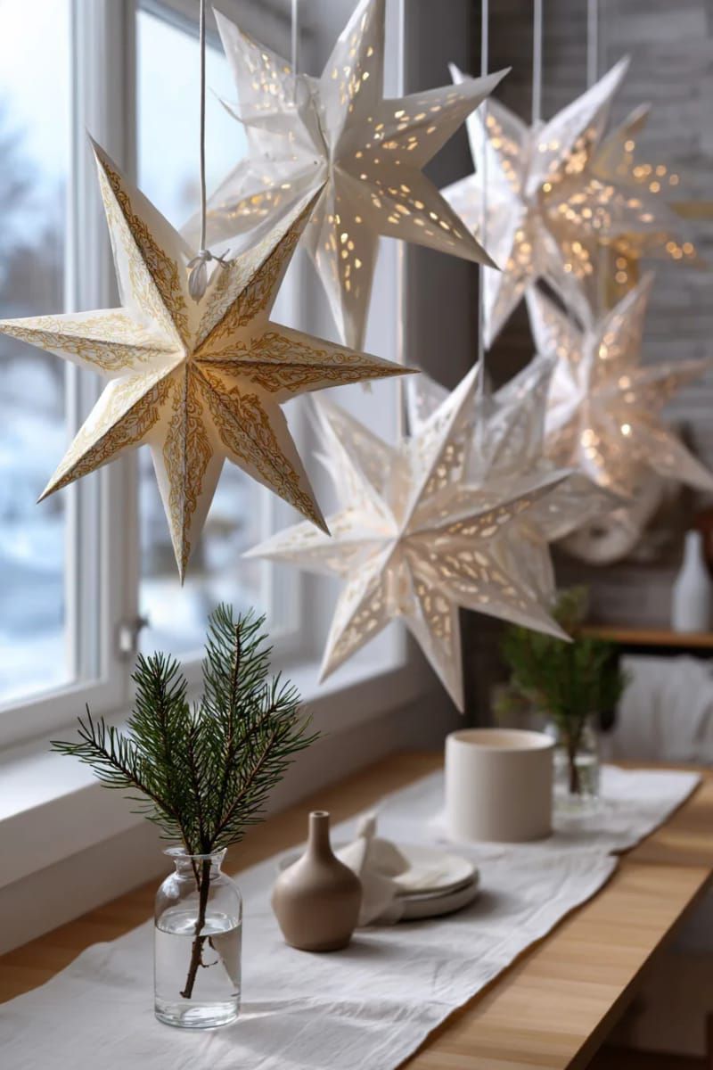 scandinavian-inspired paper star lanterns hanging in staggered heights 1