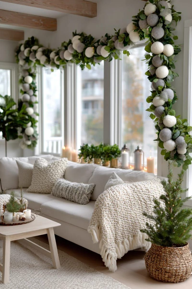 neutral wool felt ball garland draped across windows or mirrors 1