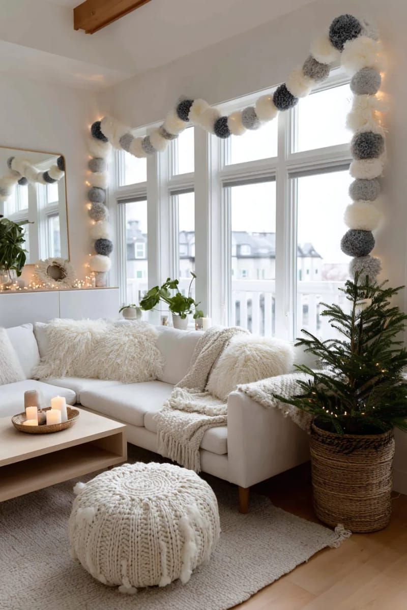 neutral wool felt ball garland draped across windows or mirrors 1
