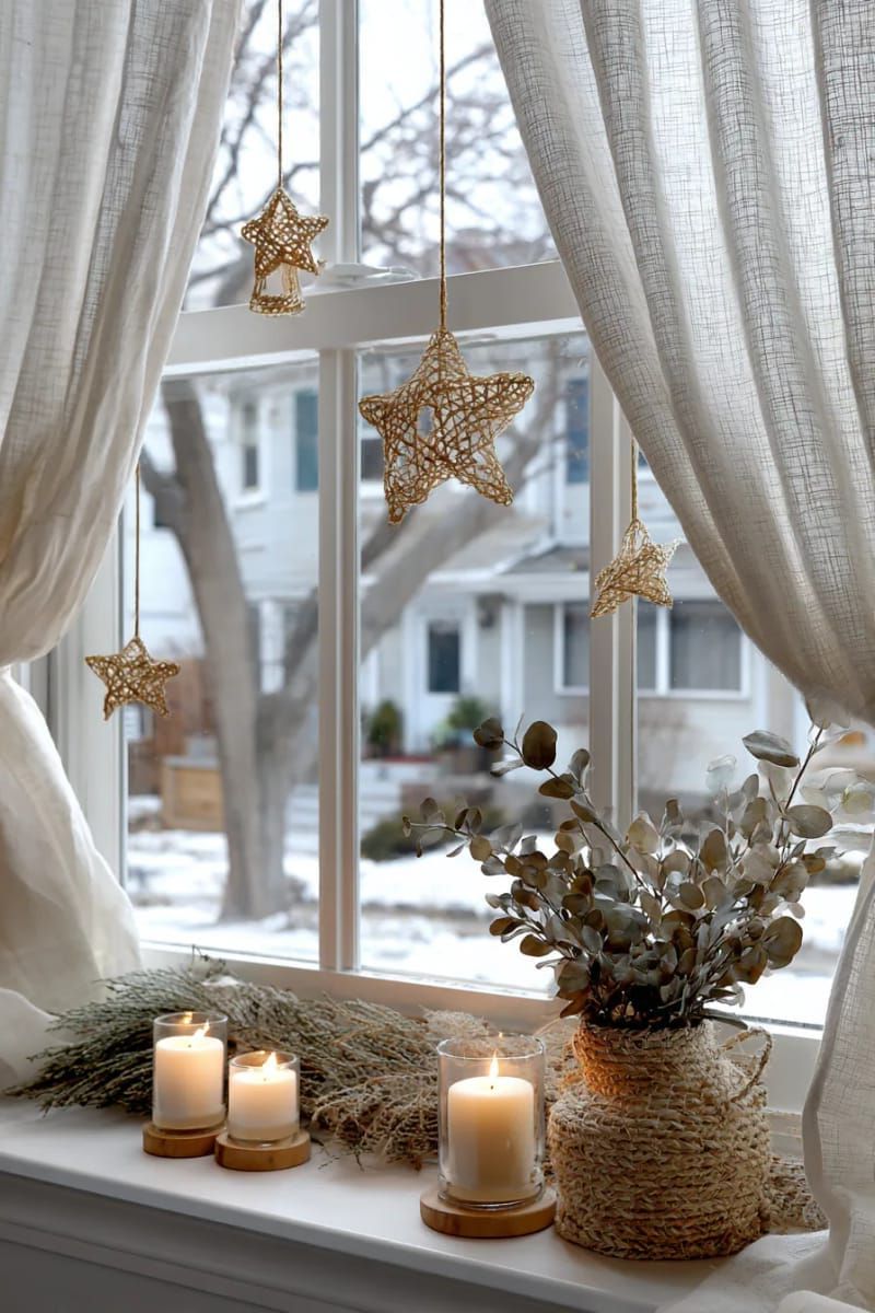 woven straw stars and bells hanging in the window 1