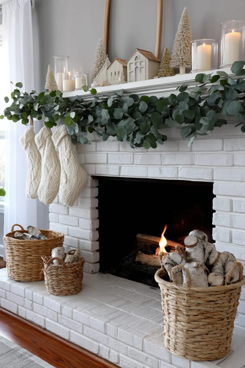 scandinavian-inspired mantel with neutral decor and wooden trees 1