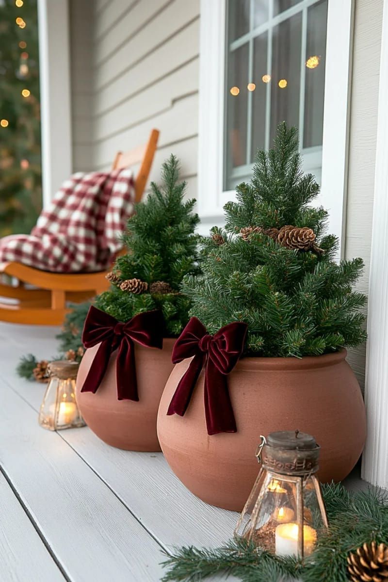 layered mini christmas trees in terracotta pots with velvet bows 1