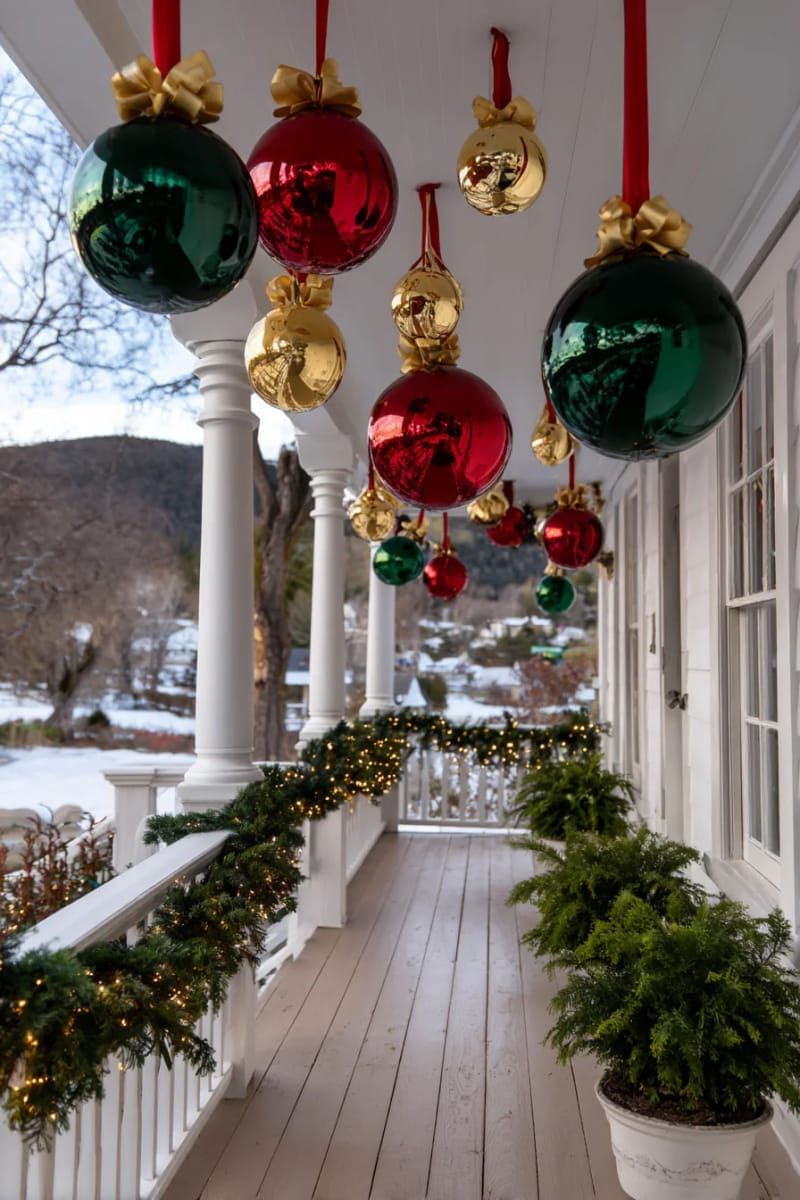 cascading oversized baubles and ribbons from porch ceilings 1