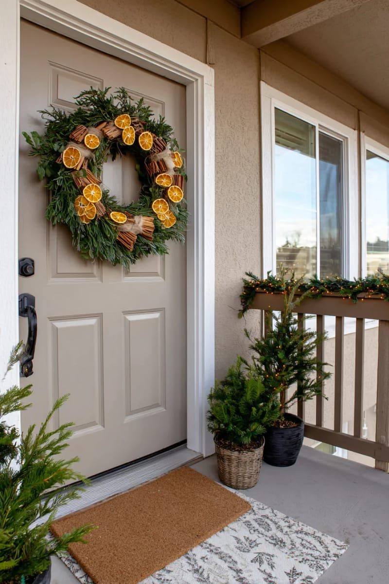 wreath made from dried orange slices, cinnamon sticks, and greenery for the door. 1
