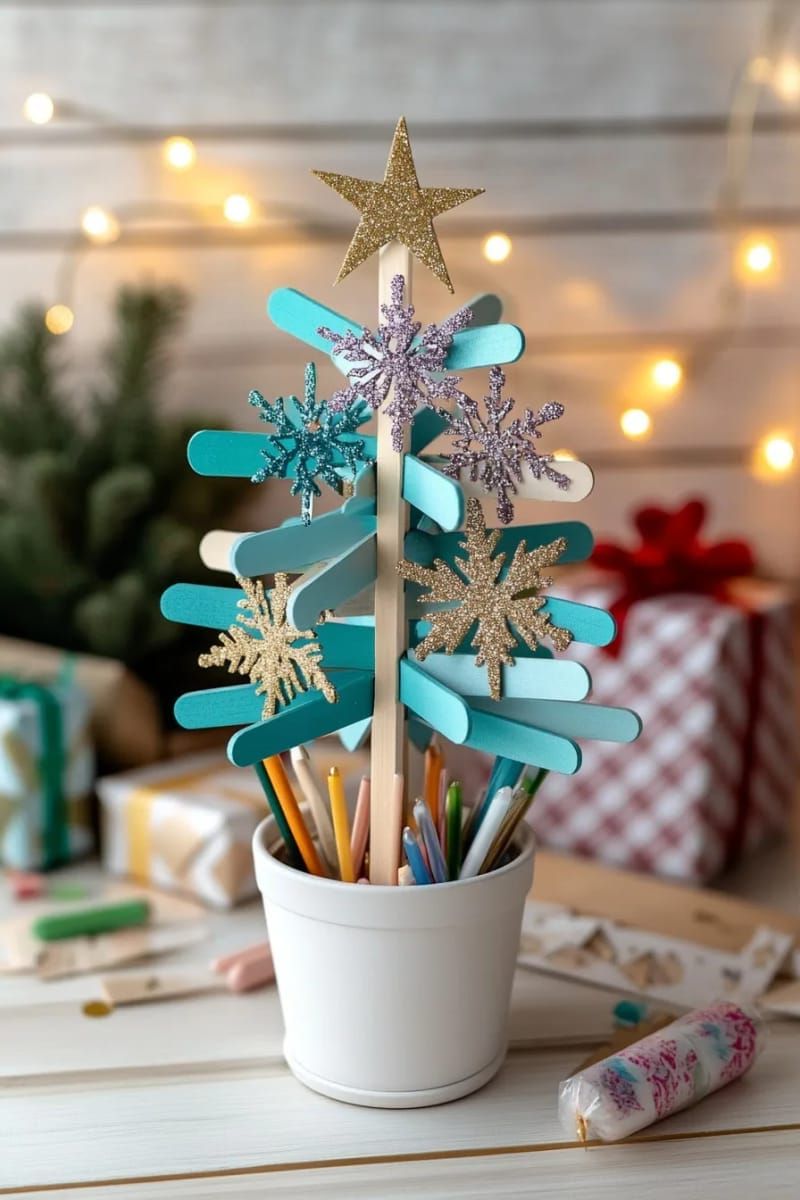 glittery snowflake and star ornaments made from popsicle sticks on a mini tree 1