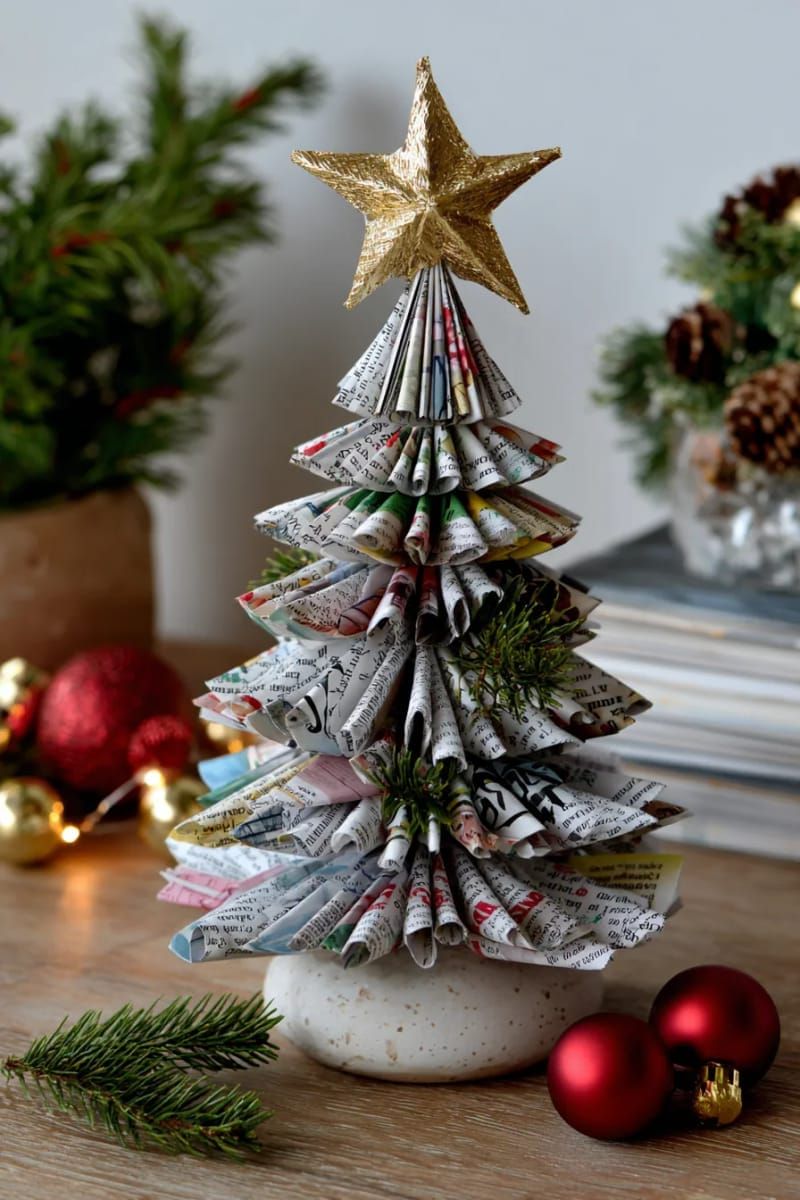 magazine page tree sculpture with a gold paper star topper 1