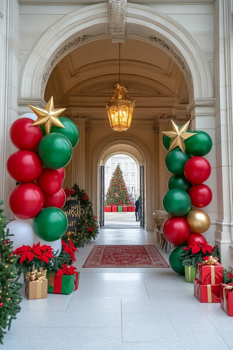 red and green balloon columns topped with golden stars at party entrance 1