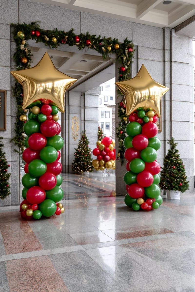 red and green balloon columns topped with golden stars at party entrance 1