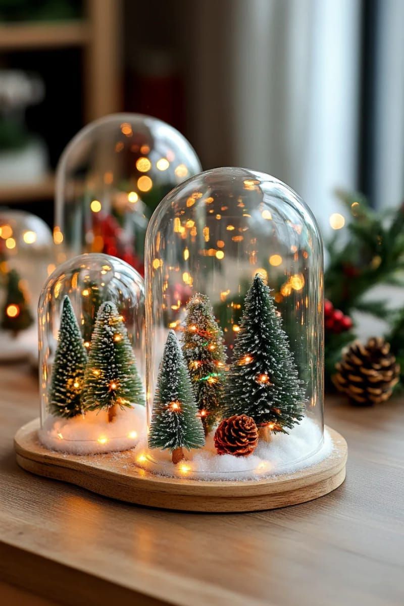 tiny tabletop trees grouped in glass cloches with fairy lights for a magical glow 1