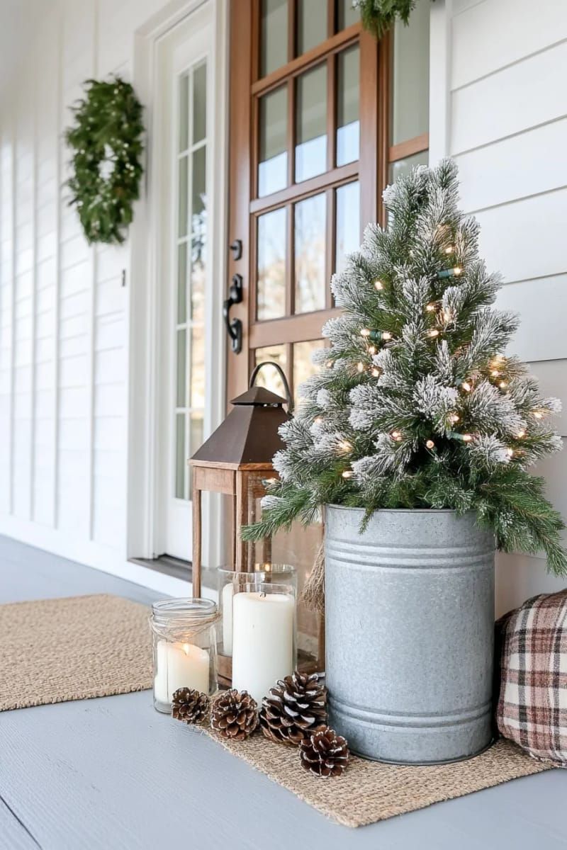 antique milk can topped with a simple flocked tree and twinkle lights 1