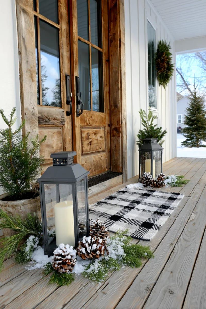 olive green and white plaid layered doormat with black lanterns and snowy pine cones 1